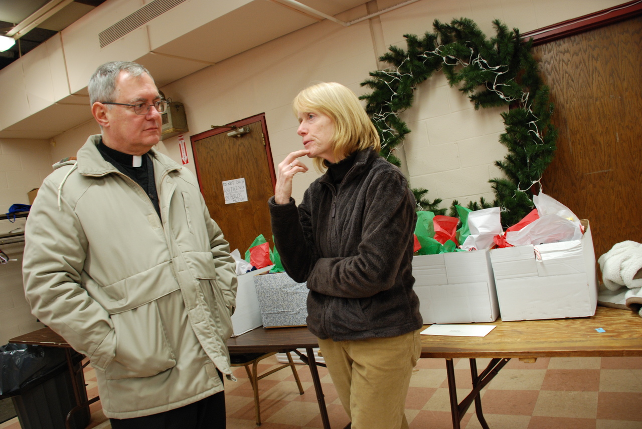 ON THE FRONT LINES: Bishop Thomas J. Tobin listens as Amos House Director and CEO Eileen Hayes describes the plight faced by many of her clients.