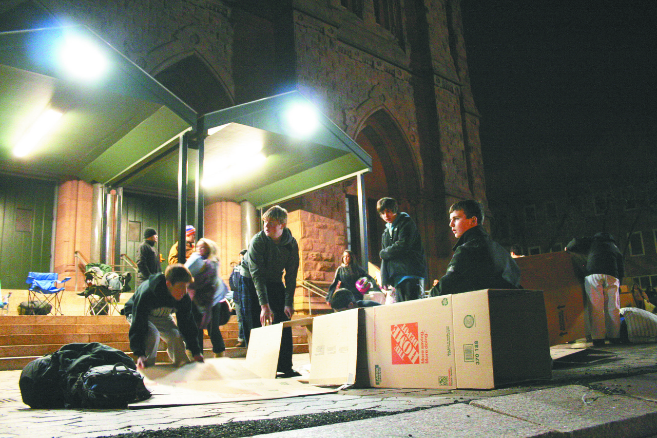 BUILDING AWARENESS: Groups of Catholic high school students prepare the boxes that will serve as their sleeping accommodations outside of the Cathedral of SS. Peter and Paul, Providence, Sunday night. More than 200 Catholic?high school students from across the state participated in the event that gave the young people a first-hand look at the rising concern of homelessness in Rhode Island.