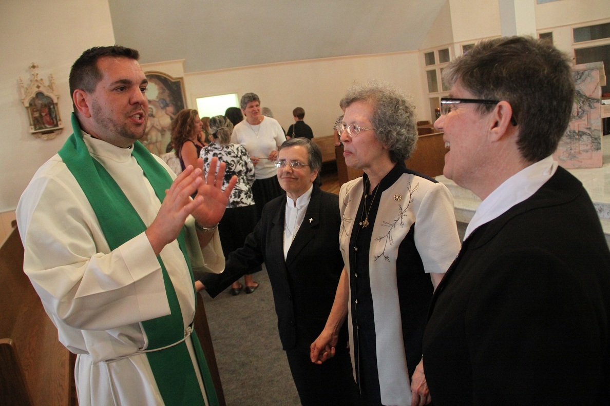 LIVES OF GRACE: Father Victor Silva, assistant pastor at St. Matthew Church, Cranston, thanks Sisters Irene Escobar, left, Mary Fatima Simas and Dorothy Schwarz on the occasion of the centennial of their order for inspiring him to pursue a priestly vocation. Father Silva was a student of the St. Dorothy Sisters as a member of Holy Rosary Parish, Providence.