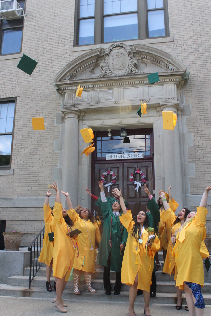 HATS OFF: St. Patrick Academy celebrates its first graduating class with a ceremony at St. Patrick Church on June 7. The graduates rejoice on the lawn shortly after earning their diplomas.