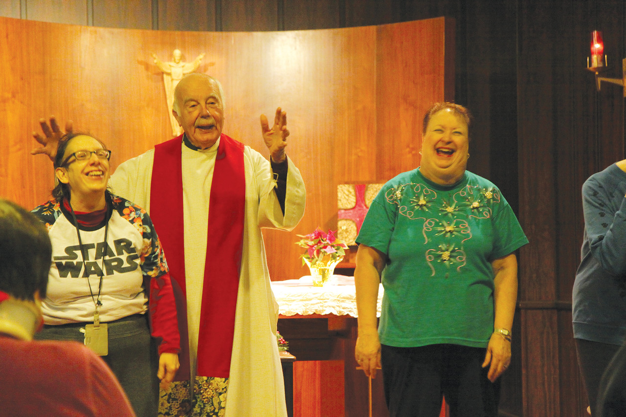 A REMARKABLE MINISTRY: Msgr. Gerard Sabourin, now retired from his long-term post as chaplain of the Apostolate for People with Disabilities, acts out a Bible story with SPRED participants during a Mass at the Father Marot CYO Center in Woonsocket.