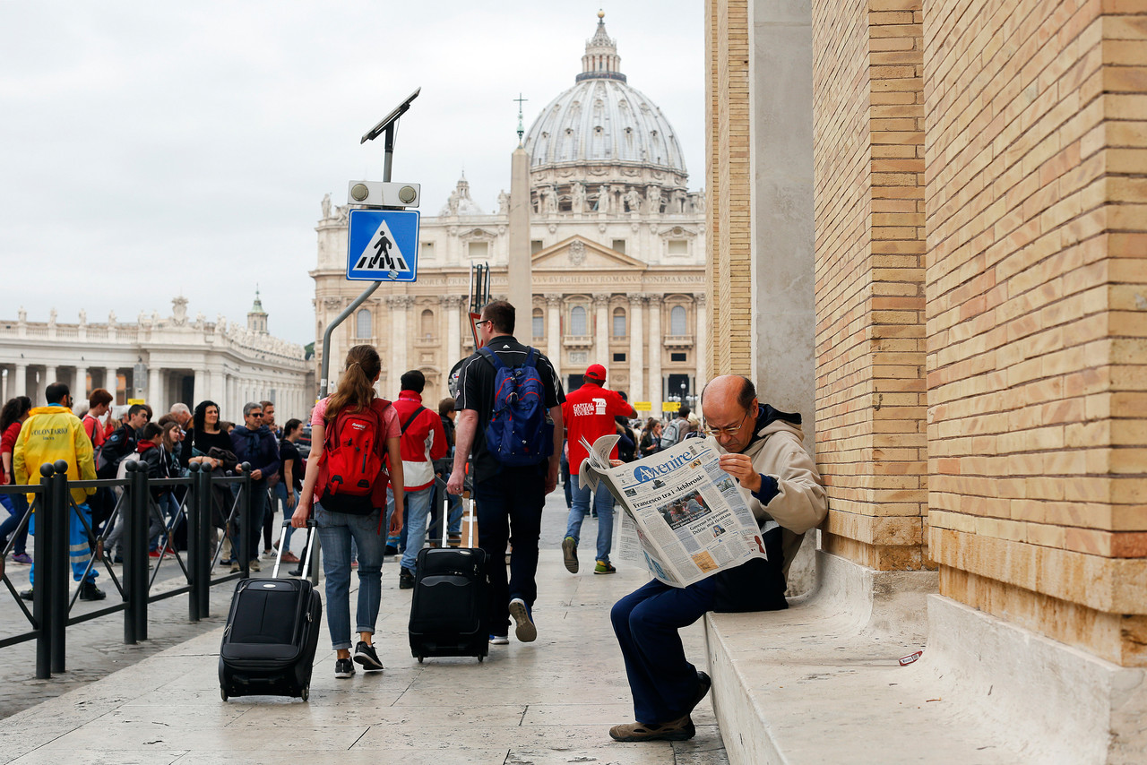 A man reads a newspaper in front of St. Peter's Square at the Vatican April 8. In his postsynodal apostolic exhortation released that day, Pope Francis said the same mercy and patience that are essential for building a strong family must be shown to those whose families are in trouble or have broken up.