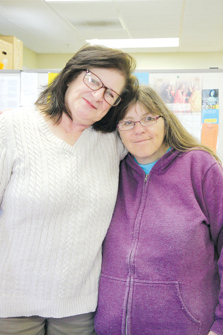 COMMITTED TO CARING: Darlene Lemoi, left, director of the Kent County satellite office, and Margaret Briggs, a regular client, pose for a photo during the morning rush last Saturday. “She is wonderful. She helps out when we need it,” said Briggs.