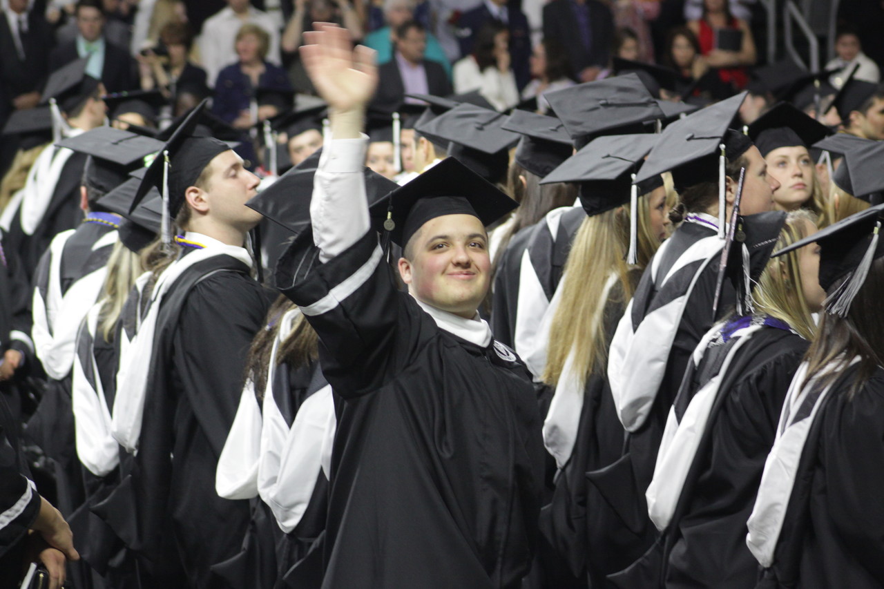 PROUD ACHIEVEMENT:  Peter Cotnoir, a seminarian for the Diocese of Providence, waves to his family at the Providence College commencement ceremony on Sunday. In the fall, he will attend St. John’s Seminary in Brighton, Mass., where he will continue his formation for the priesthood as a major seminarian. “It’s only really God working through you,” he said. “By the time I’m done, God will get me where I need to be.”