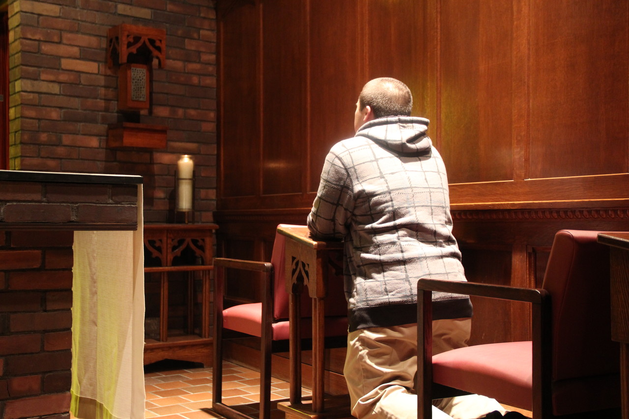 PREPARING FOR HIS VOCATION: Seminarian Peter Cotnoir kneels before the Blessed Sacrament in Harkins Oratory, a quiet prayer space on Providence College’s campus where he says he often went as a student to pray between classes.
