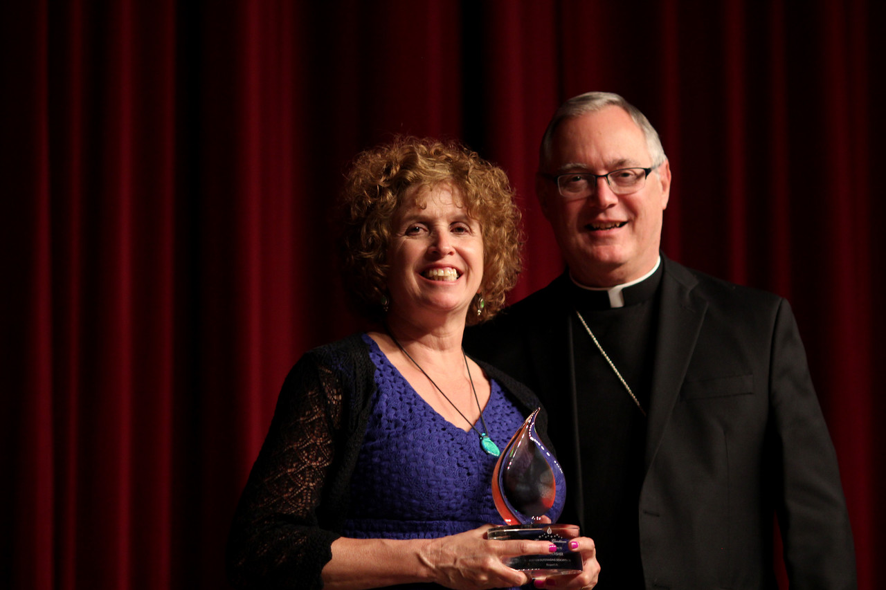 Barbara Fisher receives an award from Bishop Tobin for dedicating her time and efforts to respect life ministry.