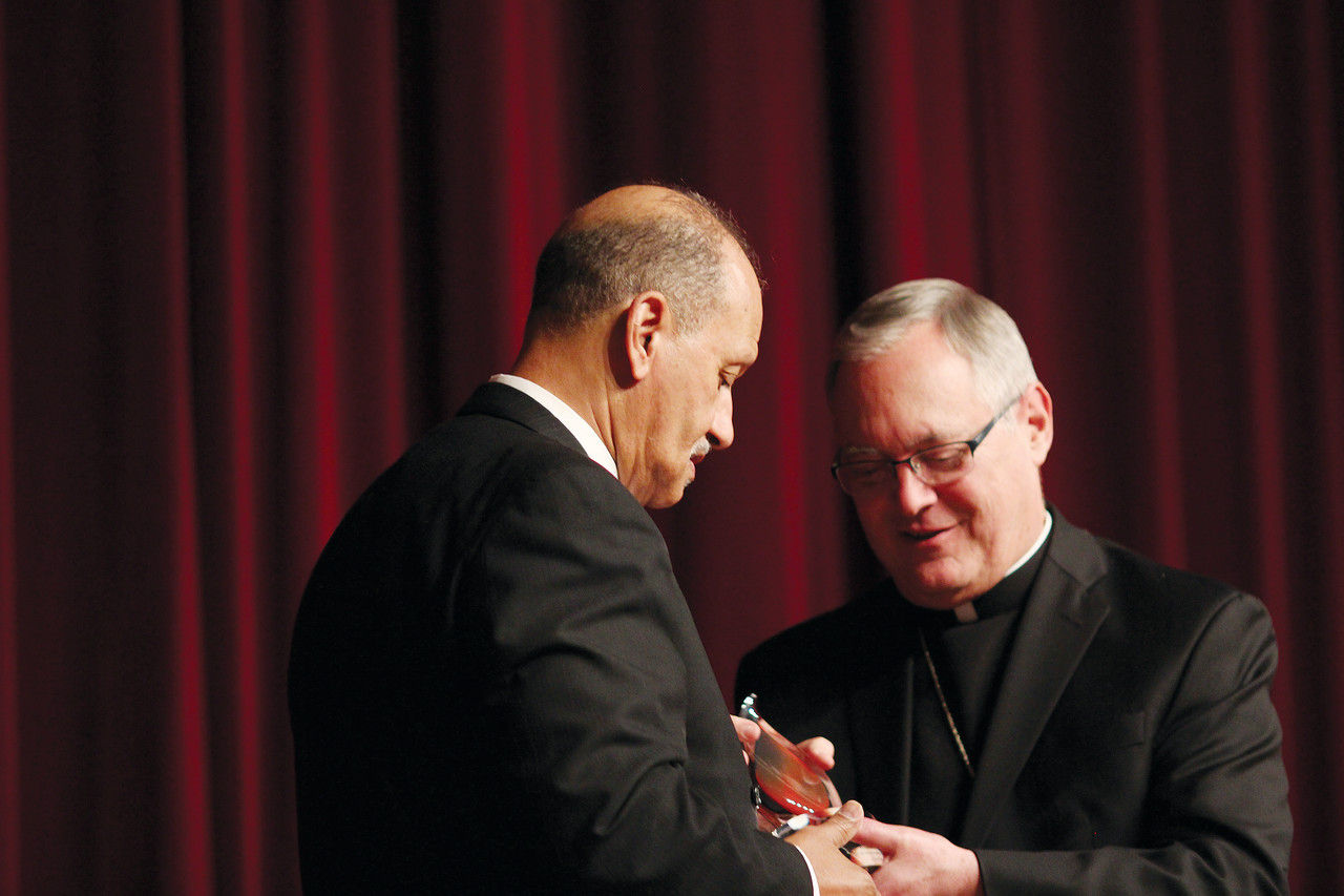 Bishop Thomas J. Tobin presents Sen. Harold Metts, a deacon at Congdon Street Baptist Church, with a Lumen Gentium Friend of the Diocese Award, for his strong commitment to Christian values.