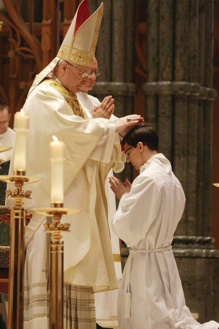 Auxiliary Bishop Robert C. Evans performs the Laying on of Hands and Prayer of Ordination to Battey.