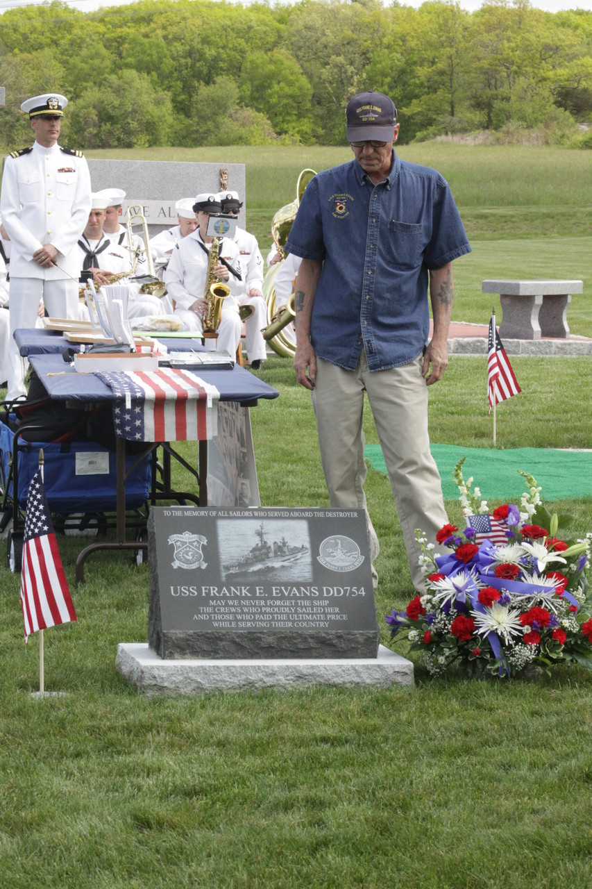 AN HONOR AND A PRIVILEGE: USS Frank E. Evans survivor Bill Thibeault observes a moment of silence beside a memorial stone commemorating the 74 crew members who died aboard the ship. The stone was placed at Resurrection Cemetery in honor of Cumberland native Frederic Conrad “Dick” Messier, Jr., a friend of Thibeault’s and victim of the disaster.
