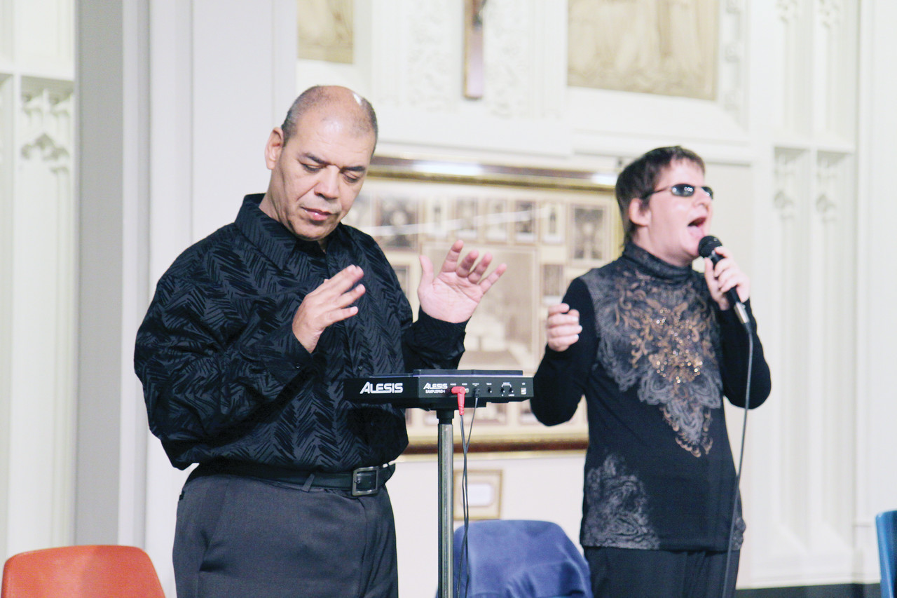 At left, percussionist Henry Rodriguez and vocalist Diane Parenteau perform with the group Blind Faith at a reception following the pilgrimage to the Holy Door. The members of the band, which also includes keyboardist Matthew Ventre, have all been blind since birth.