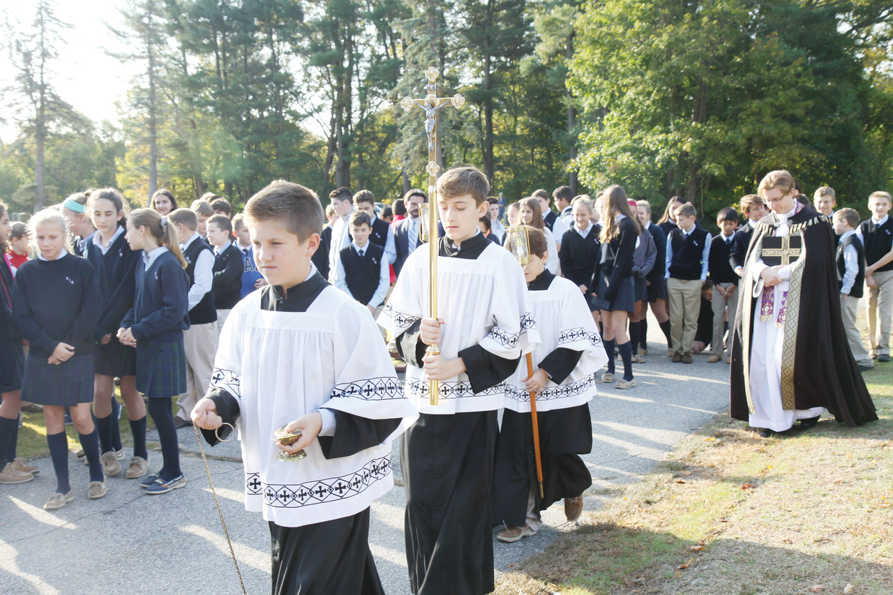 Seventh-grader David Lynch leads his classmates in a procession back to the school following the prayer service.