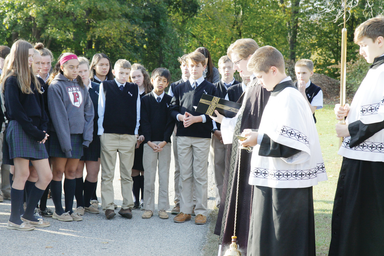 Father Joshua Barrow, associate pastor at Our Lady of Mercy Parish, leads the students in a prayer service to remember the souls of all the faithful departed.