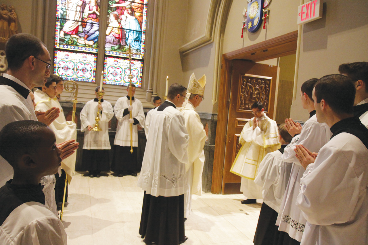 Transitional Deacon Stephen M. Battey, who will be ordained to the priesthood in June 2017, becomes the last person to pass through the special Holy Door at the Cathedral of SS. Peter and Paul before Bishop Thomas J. Tobin seals them marking the end of the Jubilee Year of Mercy promulgated by Pope Francis.