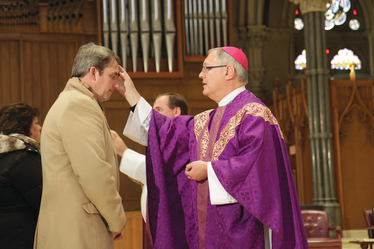 LENTEN OBSERVANCE: Bishop Thomas J. Tobin distributes ashes last year on Ash Wednesday at the Cathedral of SS. Peter and Paul in Providence.