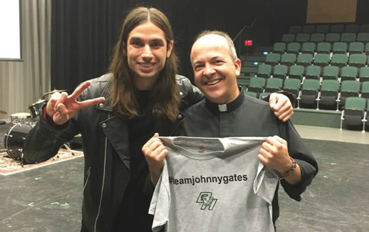 RETURNING TO HIS ROOTS: During a visit to Bishop Hendricken last week, Gates took a photo with longtime friend and mentor Father Marcel Taillon, who served as chaplain when Gates attended the school.