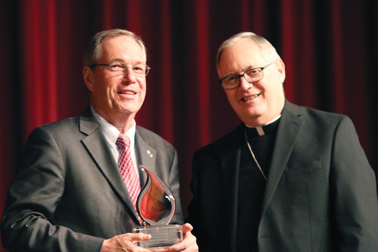 Joseph Robenhymer receives a Lumen Gentium Award for Parish Service from Bishop Thomas J. Tobin. 1,000 individuals fill the Twin River Event Center for the annual Lumen Gentium Awards whose proceeds this year will benefit the needs of senior priests.