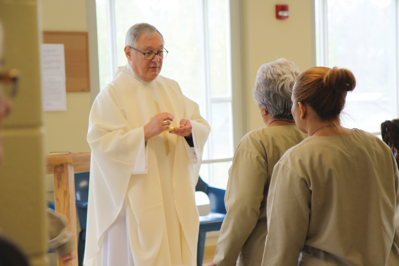 Bishop Thomas J. Tobin offers Communion to an inmate during a pastoral visit to the Rhode Island Department of Corrections Women’s Facilities on Thursday, May 11.