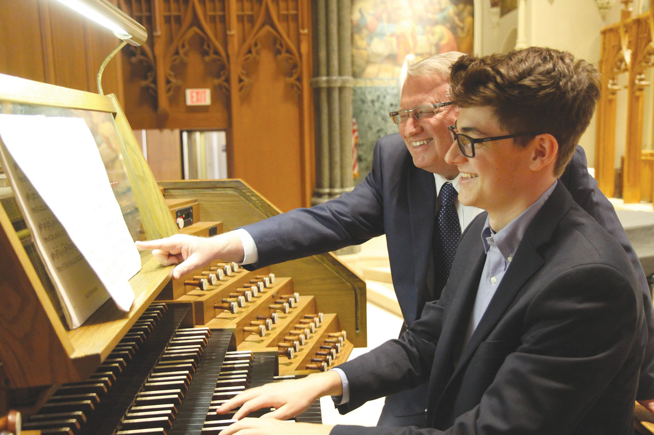 Nathan Schneider, a recent graduate of The Prout School, practices playing the organ at the Cathedral of Saints Peter and Paul with his teacher, Philip Faraone, who serves as organist at the cathedral and music director at The Prout School. Schneider will begin his studies at the Pontifical Institute for Sacred Music in Rome in October.