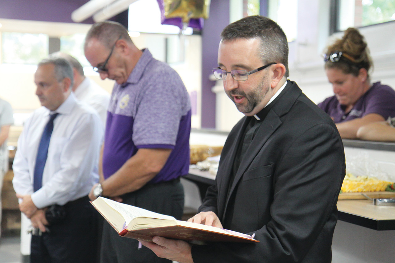St. Raphael Academy Chaplain Father Carl Fisette blesses the renovated cafeteria named in honor of Shawn Nassaney ‘94.