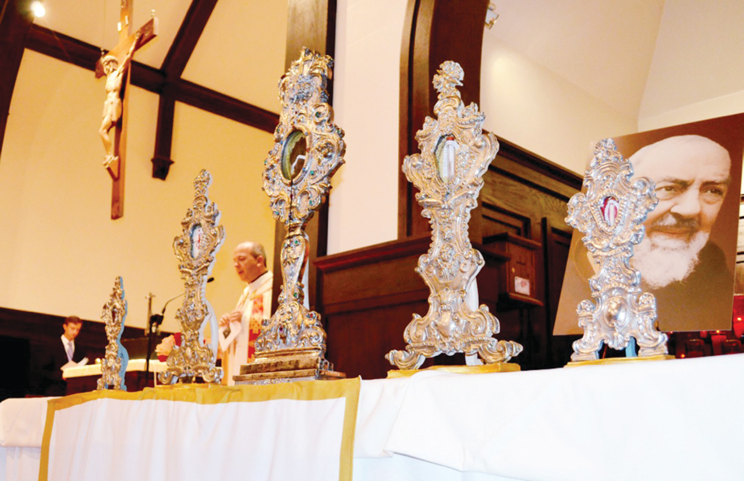 Relics of Padre Pio are showcased at St. Thomas More Church in Narragansett as Father Marcel Taillon, pastor, offers prayers during the stop on the national tour of St. Pio’s relics.