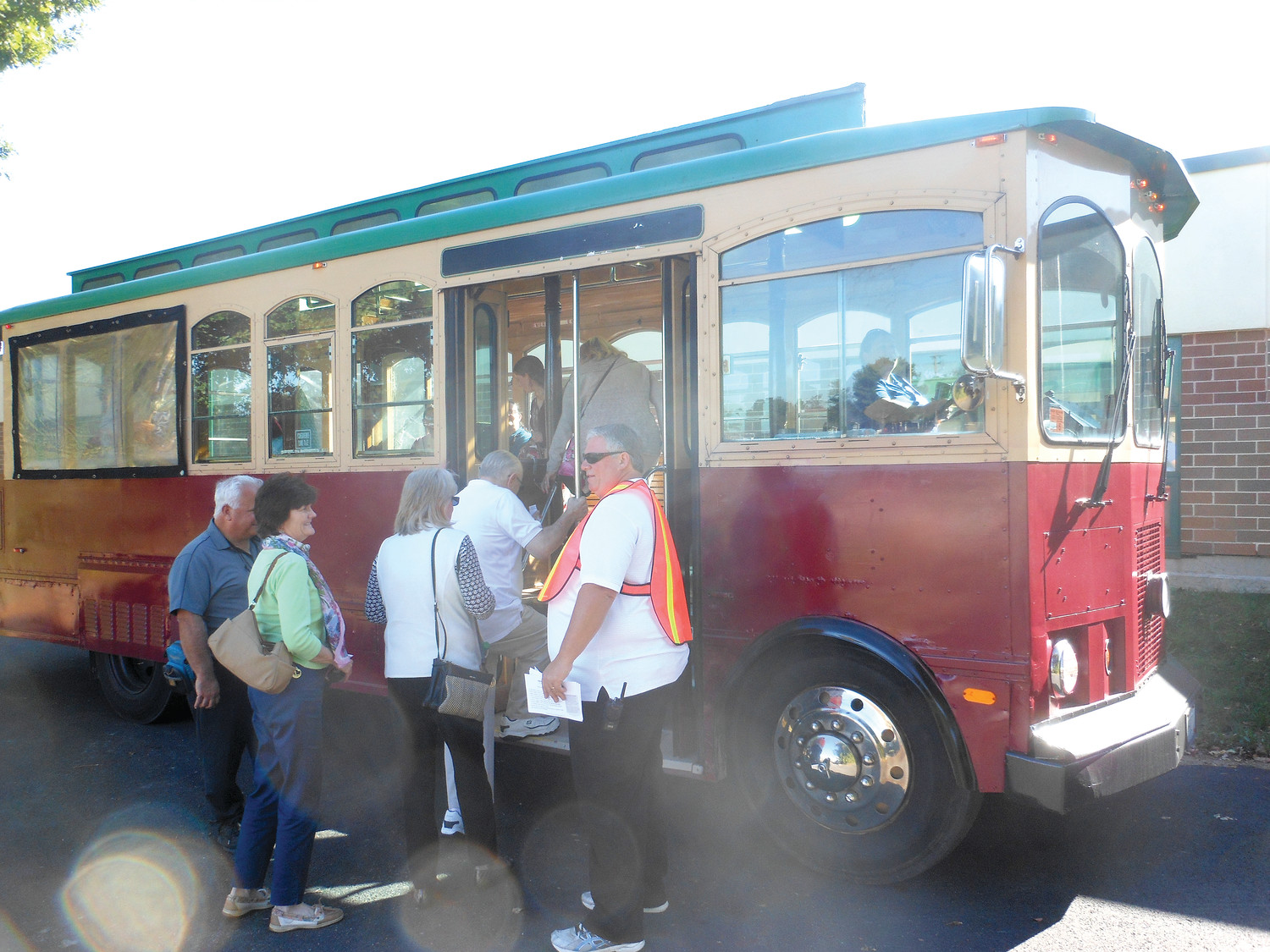 St. Thomas More parishioner Gary Tudino guides visiting pilgrims onto a trolley to take them from Narragansett High School to the church. Because police shut down Rockland Street to manage crowding, pilgrims relied upon trolleys to shuttle them to and from the church.