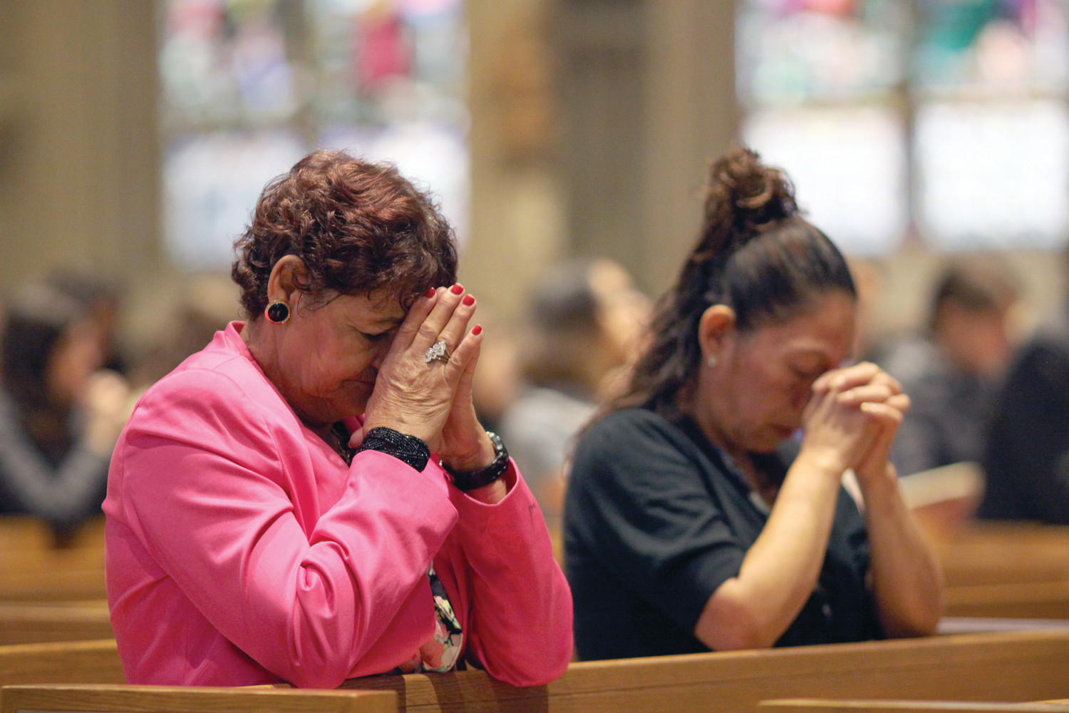 On Sunday, October 15 at the Cathedral of Saints Peter and Paul, women kneel in prayer during a Mass for those affected by recent tragedies throughout the world.