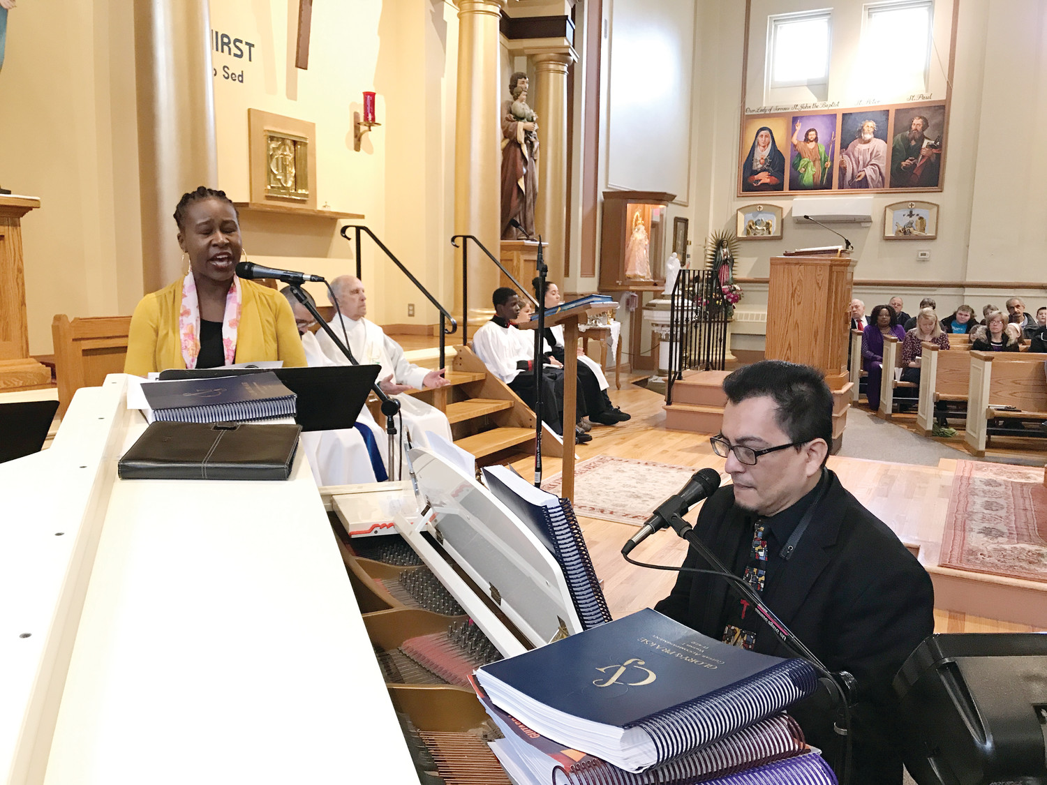 With Silvio Cuellar at the piano, Fredza Léger a member of the St. Patrick Church parish choir, sings a song in French after Communion. St. Patrick observed Black Catholic History month during the 9 a.m. Mass on Sunday, Nov. 19.