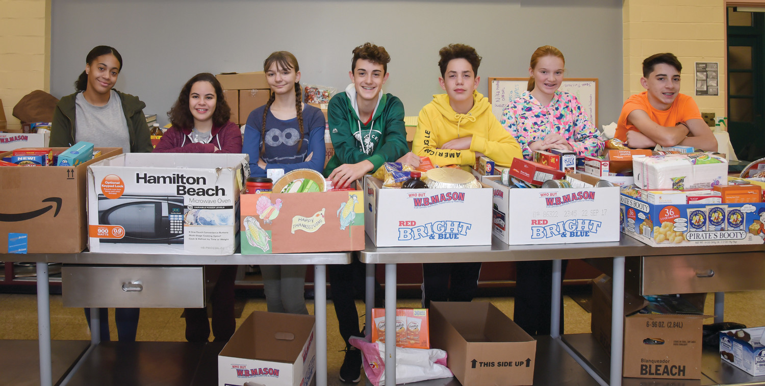 For Thanksgiving, eighth grade students at St. Augustine School in Providence, pictured above, recently held a food drive. The students collected boxes of food from each grade to help provide to eight different families as well as local food pantries.