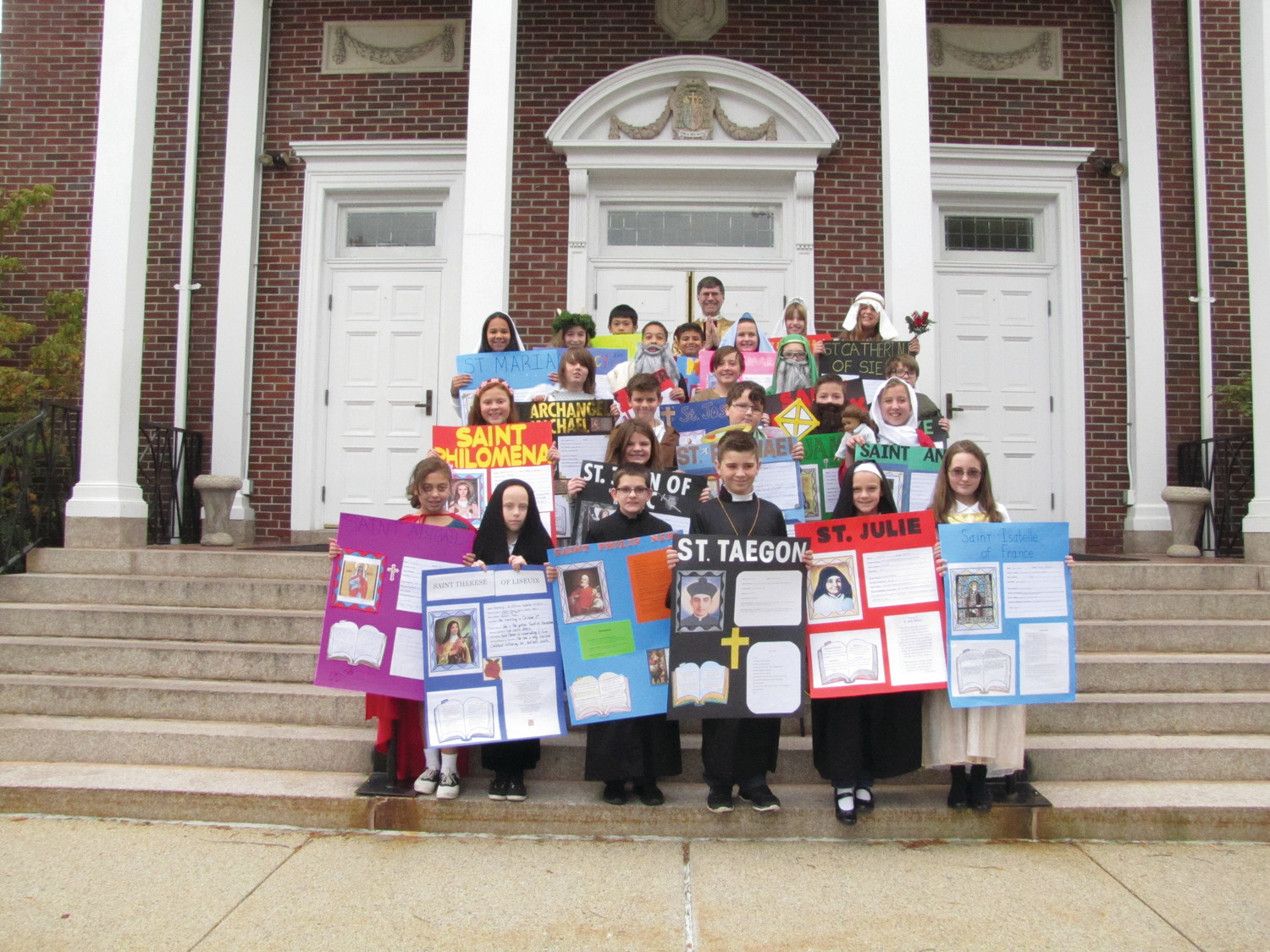 Fifth grade students at Good Shepherd Catholic Regional School in Woonsocket participated in St. Joseph Church All Saints Day Mass. Students were asked to research, make a poster and dress like their favorite saint.