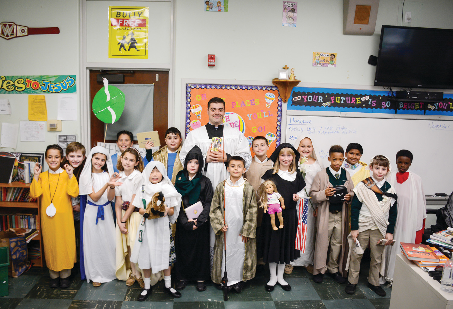 St. Augustine School teacher Ralph Cola, dressed as St. Benedict, joins his fourth grade class in representing their favorite saint. Students toured the school in costumes sharing facts about the life of the saints.