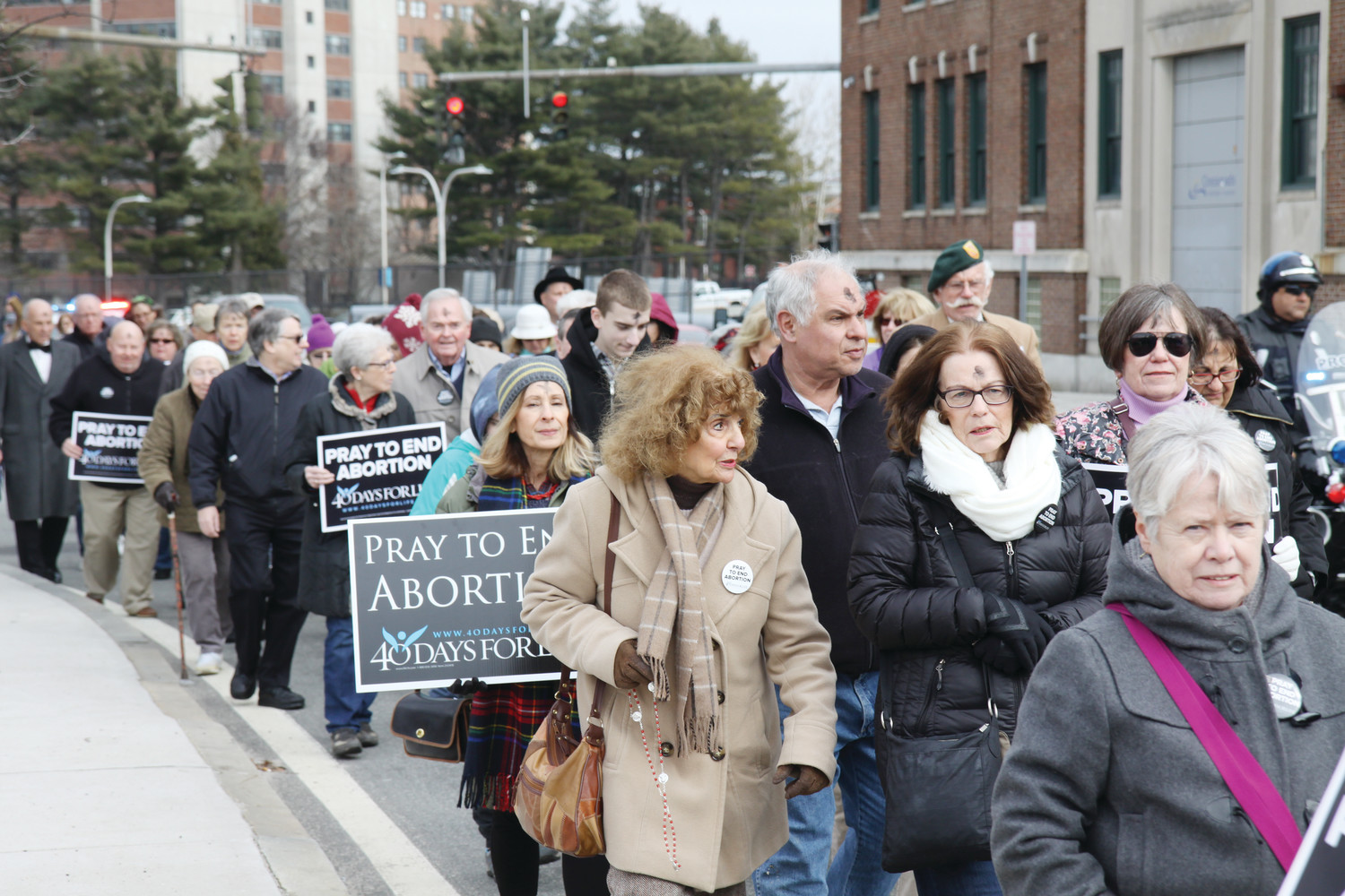 A large group of pro-life advocates, led by Bishop Thomas J. Tobin and accompanied by a police escort, marched to the Providence Planned Parenthood clinic following Ash Wednesday Mass on February 14. The procession marked the start of the 40 Days for Life Lenten prayer campaign.