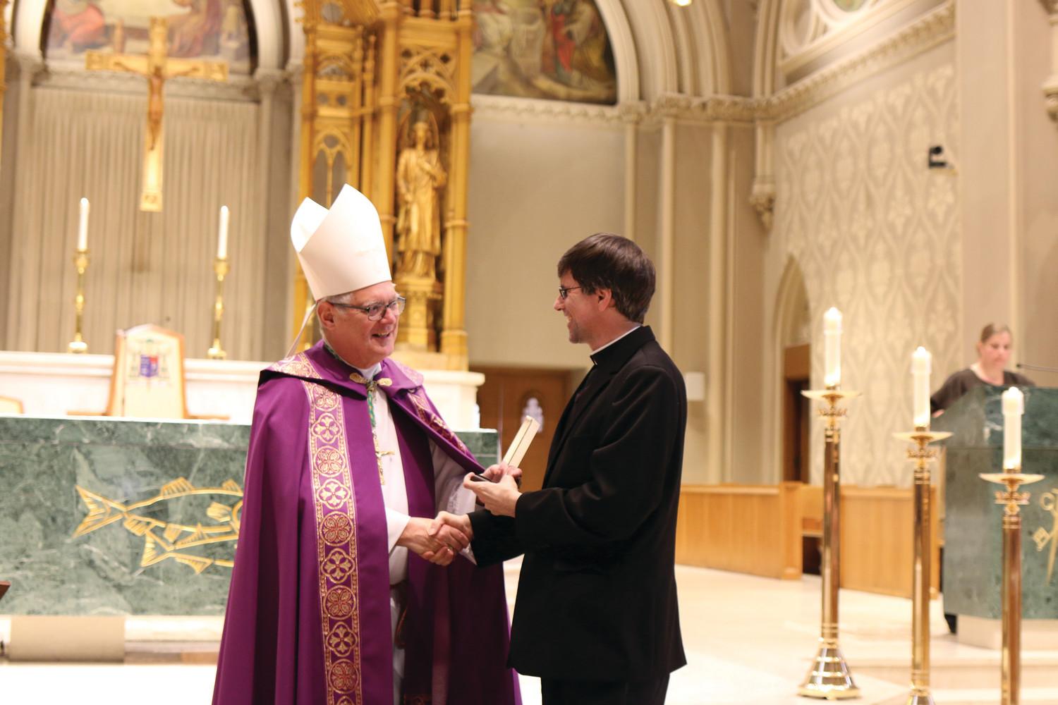 Bishop Thomas J. Tobin presents awards at the Diocesan Catholic Youth Ministry and Scout Awards celebration on Sunday, March 11, at the Cathedral of Saints Peter and Paul in Providence. Pictured: Father Michael Woolley, pastor of St. Joseph Church in Woonsocket, for his work at the Father Marot CYO Center.