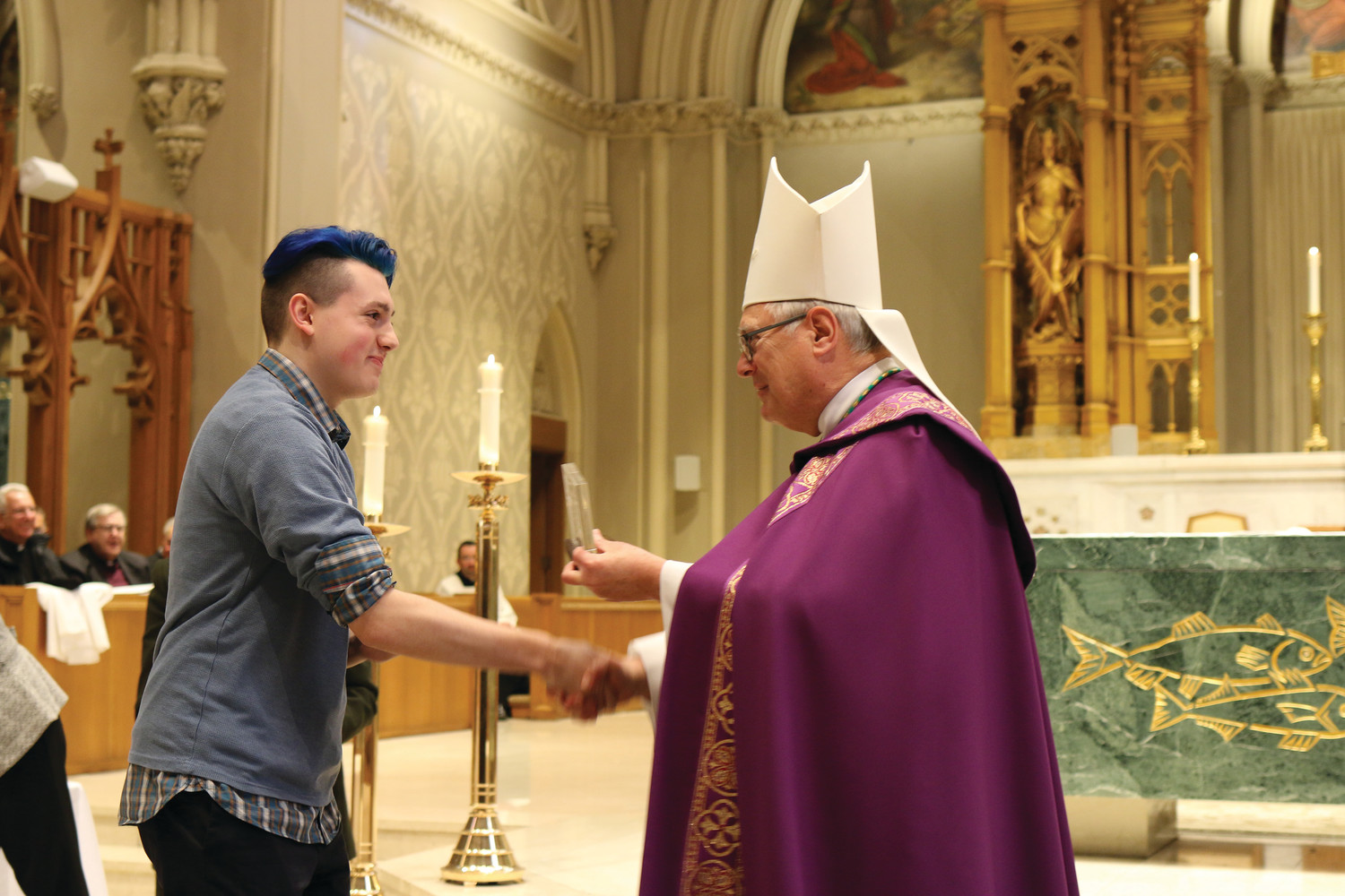 Bishop Thomas J. Tobin presents awards at the Diocesan Catholic Youth Ministry and Scout Awards celebration on Sunday, March 11, at the Cathedral of Saints Peter and Paul in Providence. Pictured: Noah Pike, parishioner of SS. Rose and Clement Church, honored with a St. Timothy Award