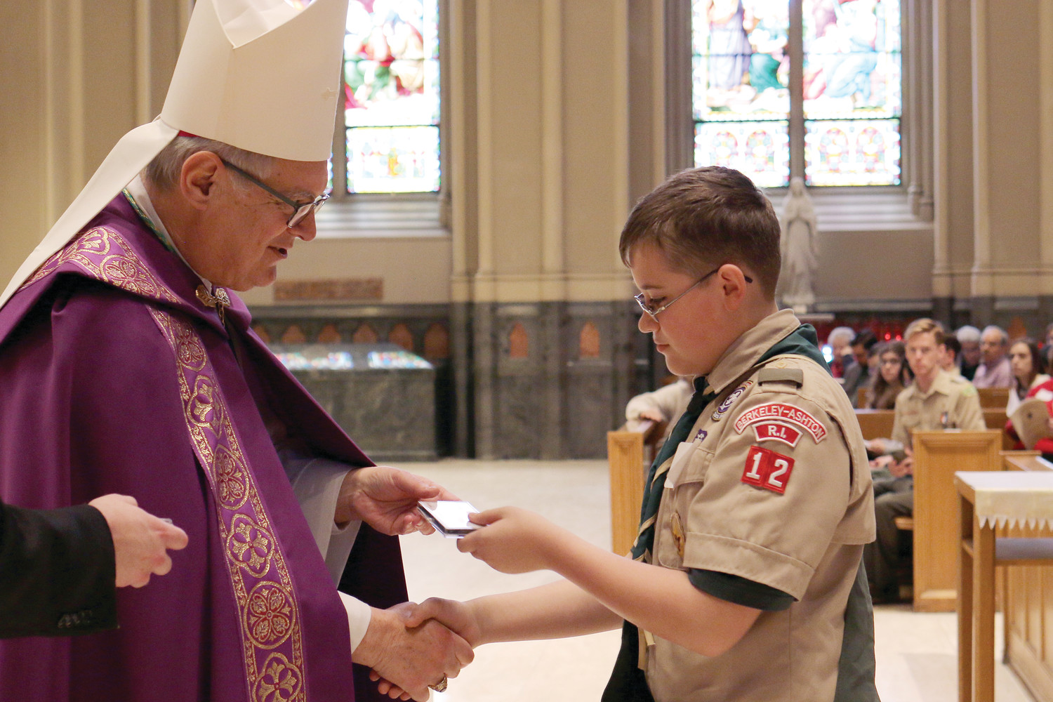 Bishop Thomas J. Tobin presents awards at the Diocesan Catholic Youth Ministry and Scout Awards celebration on Sunday, March 11, at the Cathedral of Saints Peter and Paul in Providence. Pictured: Robert Kenyon, parishioner of St. Aidan Church, honored with an Ad Altare Dei Emblem.