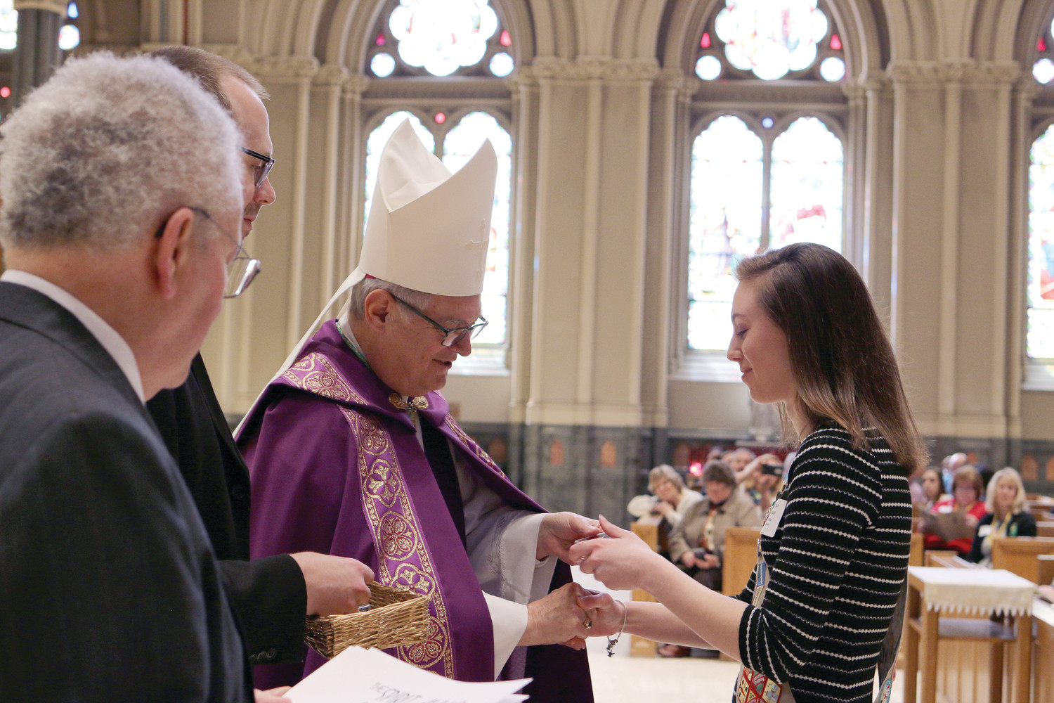 Bishop Thomas J. Tobin presents awards at the Diocesan Catholic Youth Ministry and Scout Awards celebration on Sunday, March 11, at the Cathedral of Saints Peter and Paul in Providence. Pictured: Morgan Watson, St. John Vianney Church, honored with a Spirit Alive Medal and Pillars of Faith Award