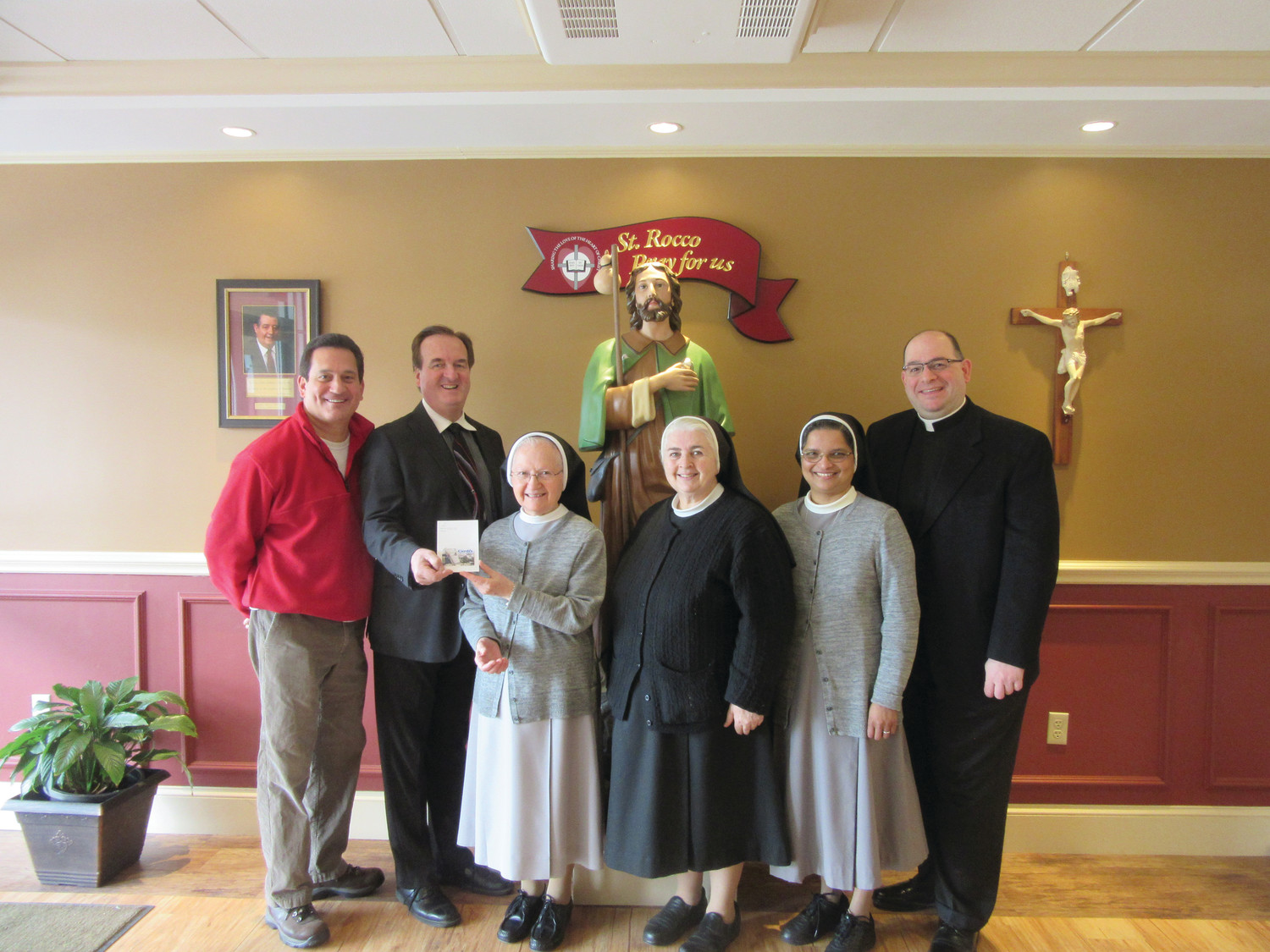 From left, Mike Montecalvo, Joe Lembo and Pastor Father Angelo Carusi present FMH Sisters Mary Antoinette Cappelli, Donna Beauregard and Daisy Kollamparampil with a Cardi’s gift card in recognition of their service and dedication.