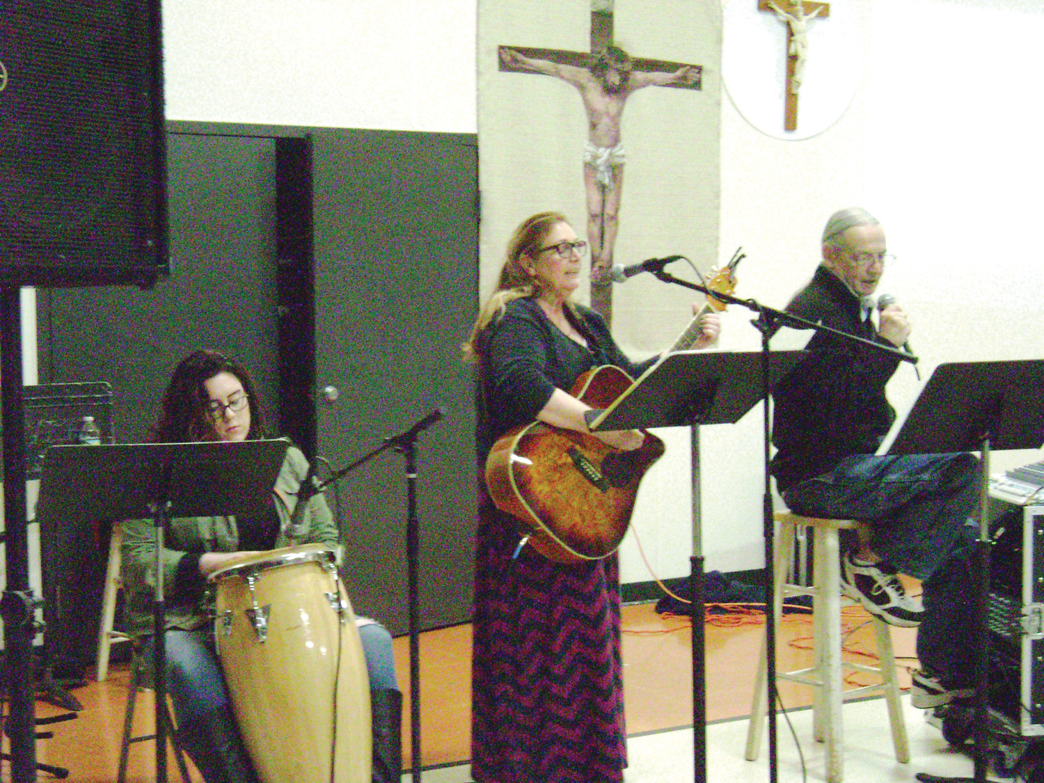 From left, praise and worship team Sarah Mulholland, Mary McDonough and Bob Finnegan lead the Charismatic prayer group in song at St. Patrick’s Church on Thursday, April 19.