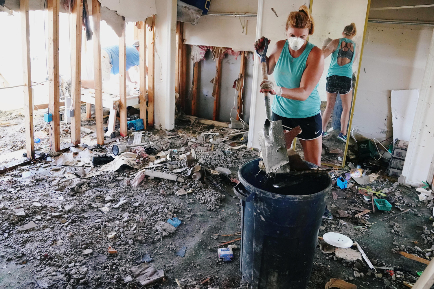 A woman cleans debris from her destoyed home Oct. 13 in Mexico Beach, Fla., following Hurricane Michael. The Category 4 storm has claimed the lives of at least 18 people.