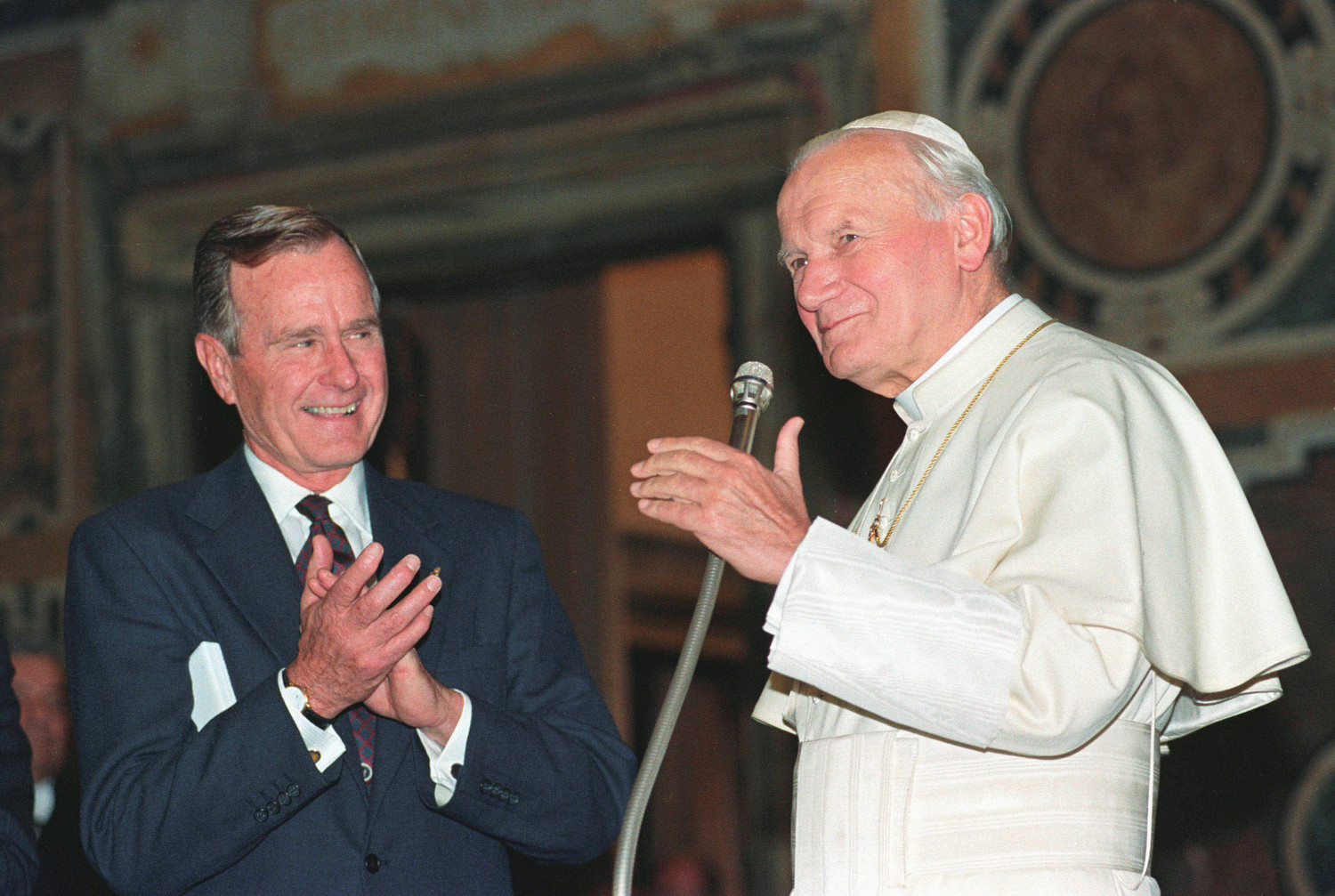 U.S. President George H.W. Bush applauds St. John Paul II after a welcoming ceremony prior to their audience at the Vatican in 1991. Bush, the 41st president of the United States and the father of the 43rd, died Nov. 30 at his home in Houston. He was 94.