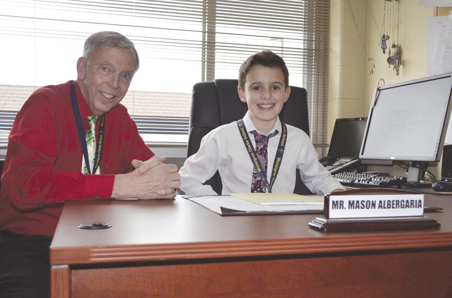 Joined by Dr. Arthur W. Lisi, principal, fifth grader Mason Albergaia smiles as he enjoys being “Principal of the Day.”