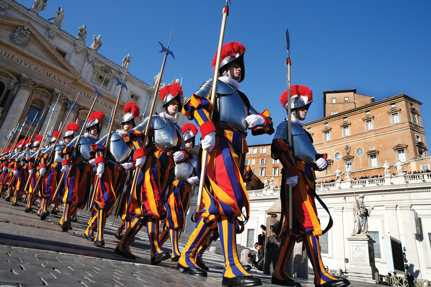 Swiss Guards march in St. Peter’s Square at the Vatican. To better protect minors and vulnerable adults from all forms of abuse and exploitation, Pope Francis approved a new law and a set of safeguarding guidelines for Vatican City State and the Roman Curia.