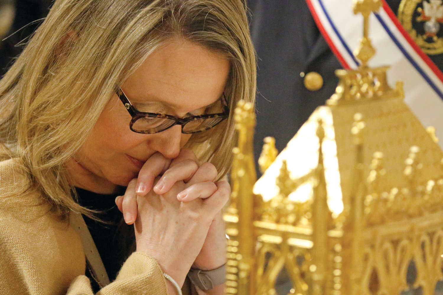 PRAYERFUL OPPORTUNITY COMES TO PROVIDENCE: A woman kneels in prayer as she venerates St. John Vianney’s incorrupt heart at St. Patrick’s Cathedral in New York City April 7, 2019. The relic of the 19th-century French priest and patron of parish priests is on a six-month Knights of Columbus-sponsored tour of the U.S.