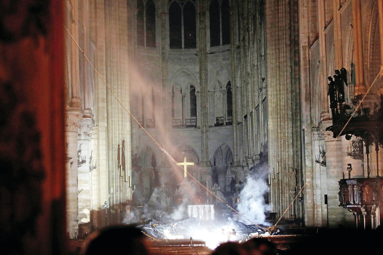 Smoke rises around the altar inside Notre Dame Cathedral in Paris as a fire continues to smolder early April 16, 2019. Officials said the cause was not clear, but that the fire could be linked to renovation work.