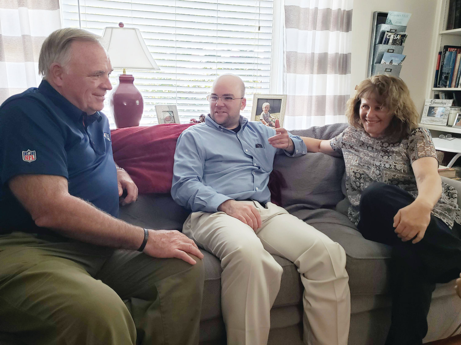 Deacon Brendan Rowley visits with his parents, James and Deborah Rowley, in the family’s Narraganset home a couple of weeks before his ordination.