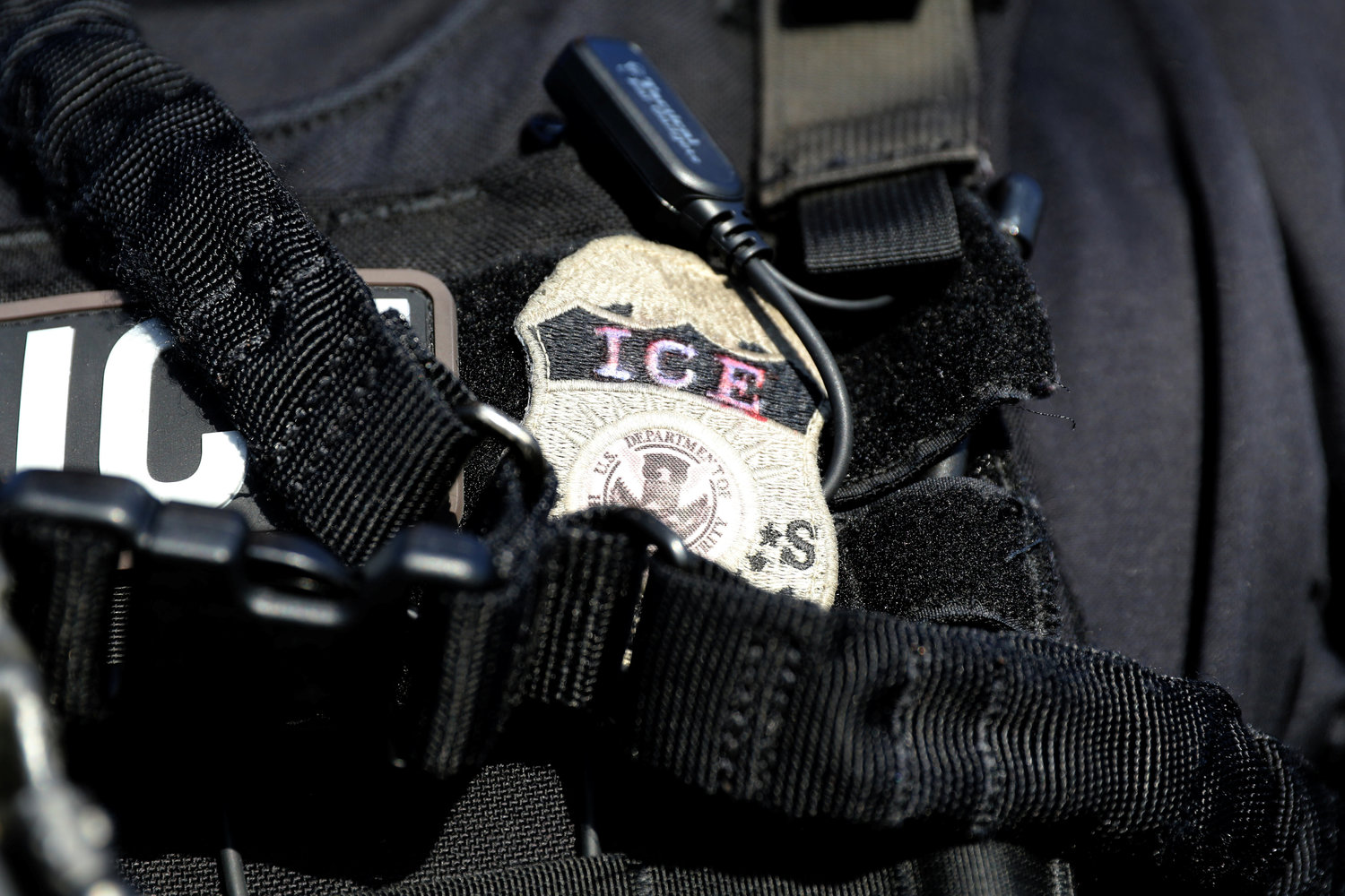 The badge of an U.S. Immigration and Customs Enforcement officer is seen in Santa Ana, Calif.