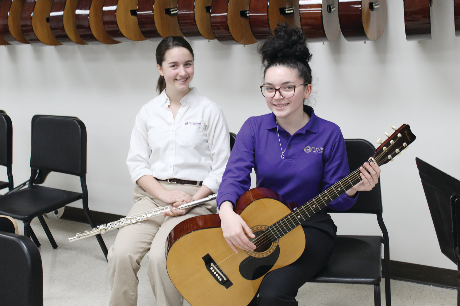 Two students from St. Raphael Academy in Pawtucket were chosen as All-State Musicians. Adelina Steinmetz, at left,  was selected to play flute in the senior division orchestra, and junior Camille Santos, was chosen for the senior division guitar ensemble.
