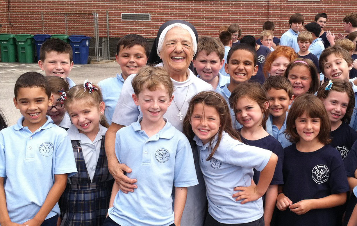Students gather around their beloved Sister Mary Angelus at St. Peter School in Warwick.