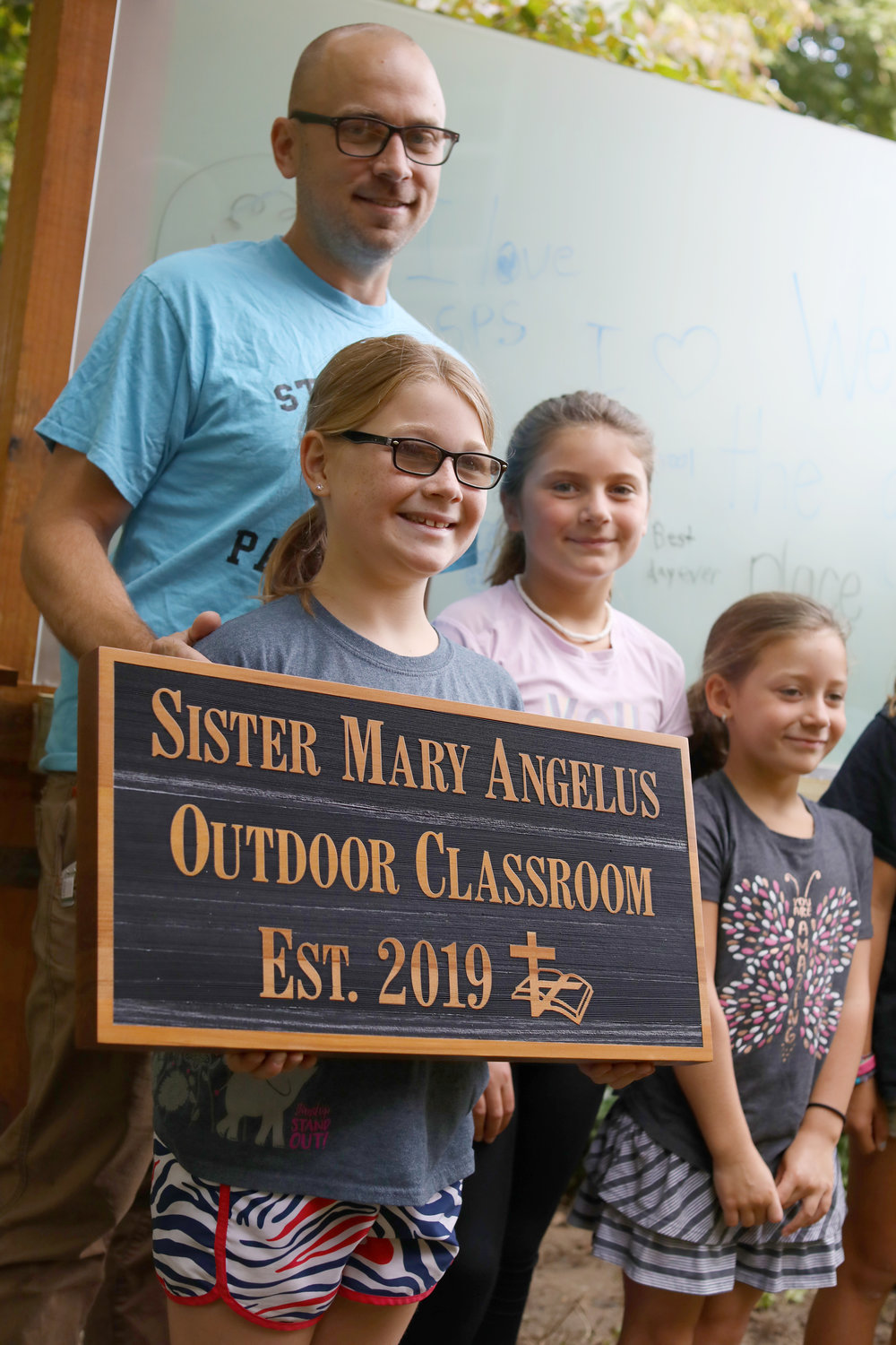 The new Outdoor Classroom at St. Peter School was dedicated to Sister Mary Angelus this past year. Students and parents gather for a photo during the summer of 2019.