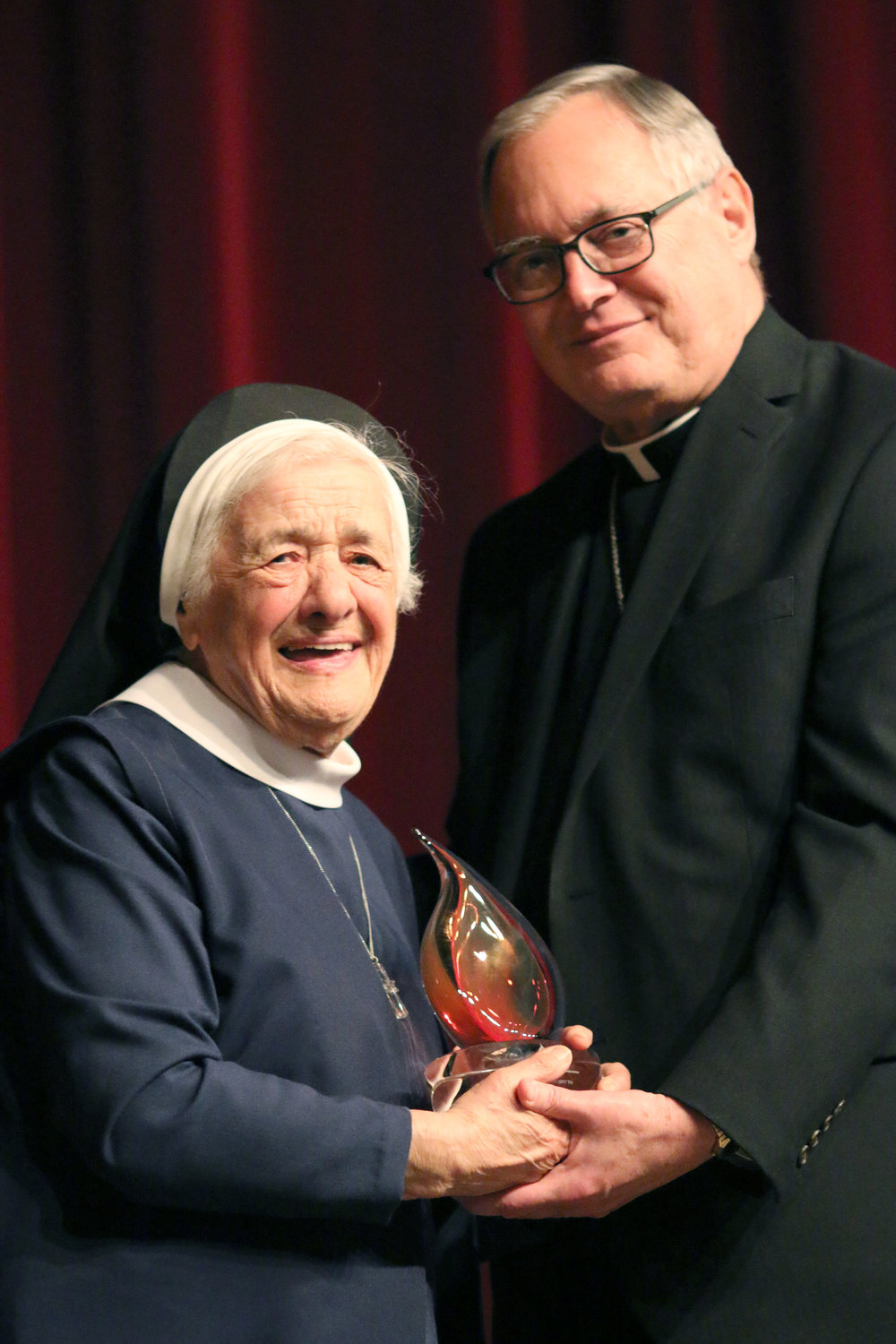 Bishop Thomas J. Tobin presents Sister Mary Angelus with a Lumen Gentium Award. In 2017, the Diocese of Providence honored her with this special Lifetime Achievement Award in Catholic Education.