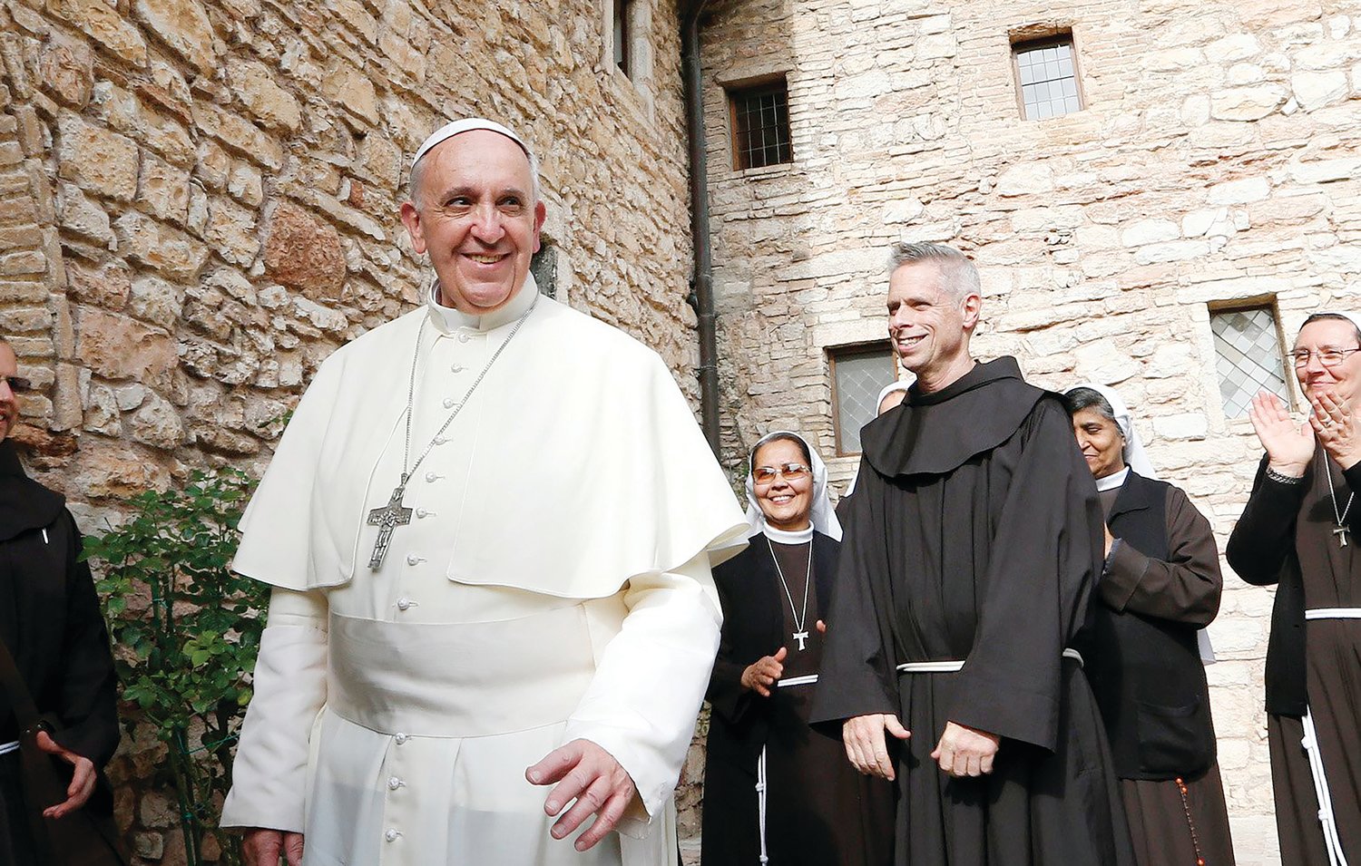 Pope Francis greets religious as he leaves the hermitage and cell of St. Francis in Assisi, Italy, in this Oct. 4, 2013, file photo. The pope plans to visit Assisi on Oct. 3 to celebrate a private Mass and sign his new encyclical on human fraternity.